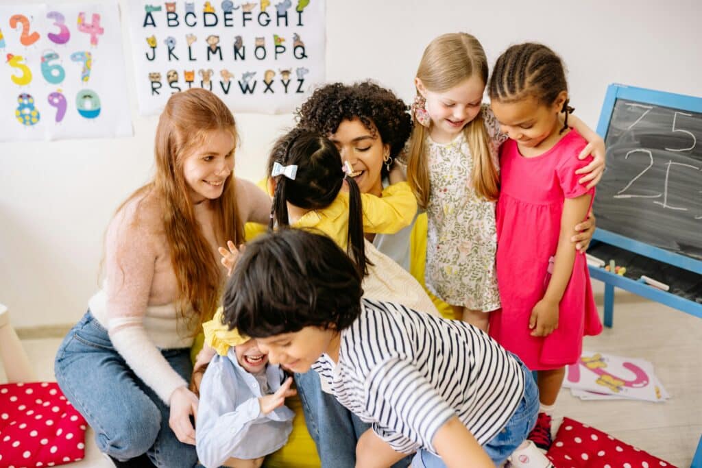 Teachers hugging children