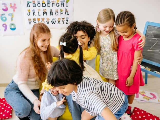 Teachers hugging children